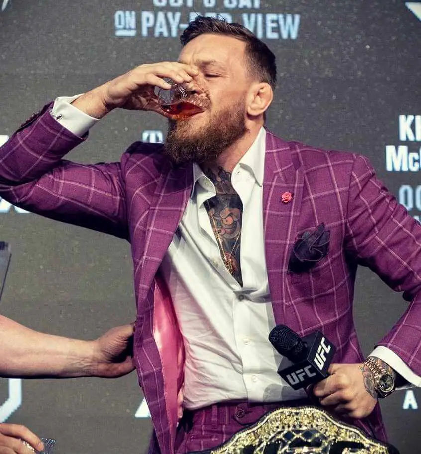 Conor McGregor having sips of his Proper Twelve during fight week in his pre fight press conference with Khabib