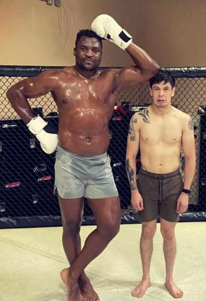 Francis Ngannou standing next to UFC former flyweight champion Brandon Moreno